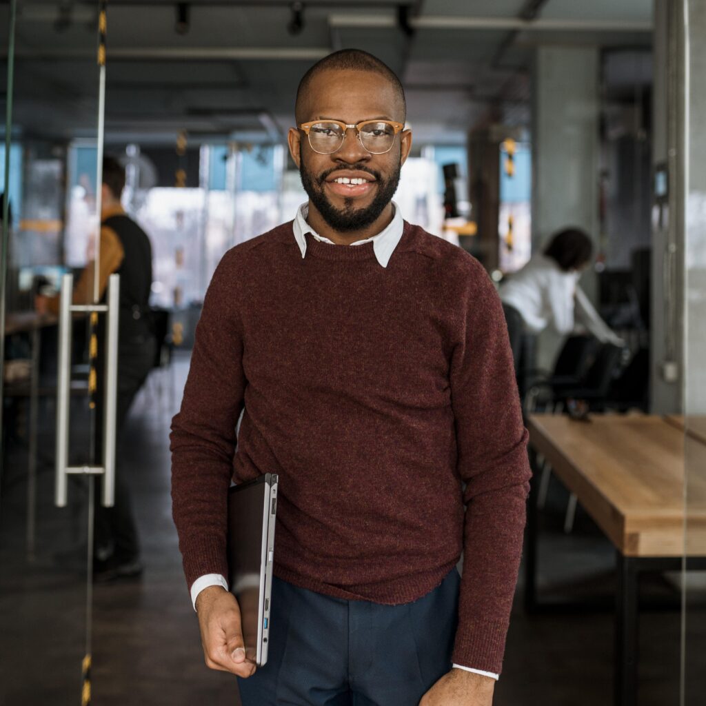 smiley man posing while holding laptop (2)
